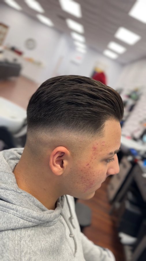 Slicked-back haircut with skin fade
